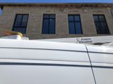 a white van parked in front of a building
