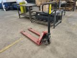 a forklift sitting in the middle of a warehouse floor
