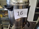 a metal container with a sign on it sitting on a table