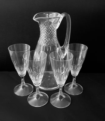 black and white photograph of a pitcher and four wine glasses