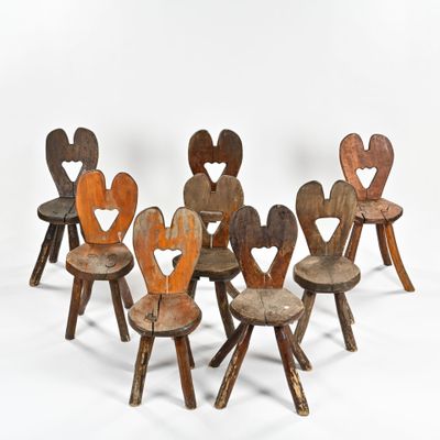 six wooden children ' s chairs are arranged in a row on a white surface