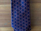 a close up of a tie on a wooden table