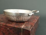 a silver bowl sitting on top of a red box