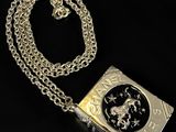 a close up of a book with a chain on a black background