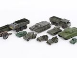 a lot of toy army vehicles and trucks on a white surface