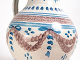 a blue and white vase sitting on a white surface