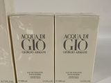 three boxes of acqua di gio cologne sitting on a white surface