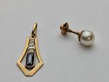 pair of earrings with black and white stones on a white surface