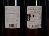 several bottles of wine are lined up on a shelf
