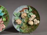 two decorative plates with flowers and fruit on them