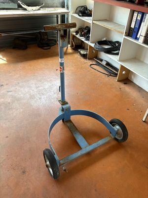 an image of a blue hand truck in a garage