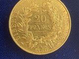 a close up of a gold coin on a blue cloth