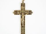 a gold cross with a crucif on it on a white background