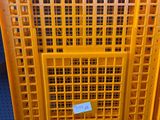 yellow plastic crates stacked on top of each other on a blue floor