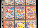 pokemon trading cards are displayed on top of a binder
