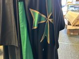 a mannequin dressed in a green and black robe