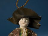 a figurine of a man wearing a hat and scarf