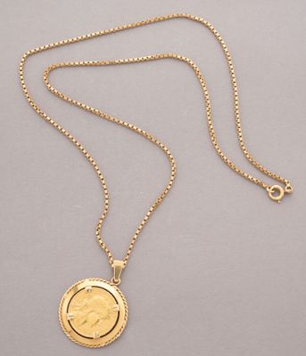 a gold coin necklace with a chain that has a coin on it
