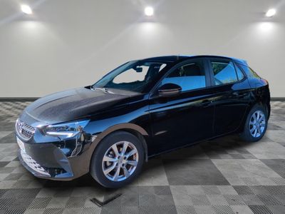 a black car parked in a garage with a checkered floor