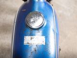 a close up of a blue motor scooter with a sticker on it