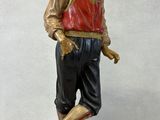 a statue of a man that is standing on a block