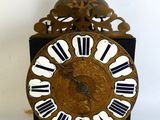 a black and gold clock with white numbers on it