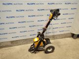 a close up of a small machine with wheels on the ground