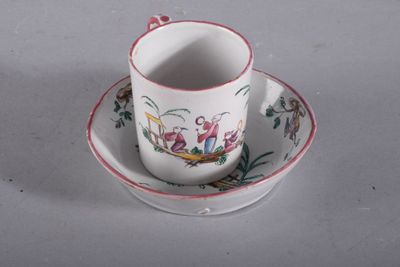 a cup and saucer with a bird design on it
