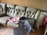 a couch that is sitting in a room with a fire extinguisor