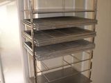 a metal shelf with several trays on top of it