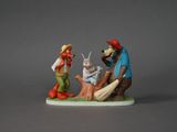 une figurine d'un homme et d'une femme avec un chien