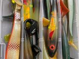 many different types of fishing lures in a plastic box