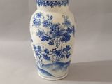 a blue and white vase sitting on a table