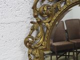 a mirror that is sitting on the wall next to a chair