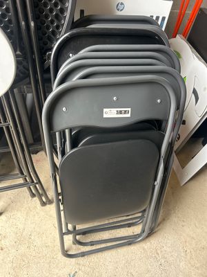 a lot of chairs that are stacked on top of each other
