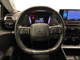 the interior of a car with a steering wheel and dashboard controls
