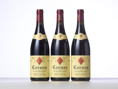 three bottles of red wine sitting on top of a table