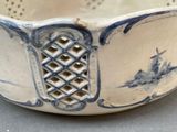 a white bowl with blue designs on it on a table