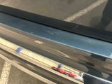 a close up of a car door handle with a sticker on it