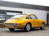 yellow car parked in front of a building on a cobblestone street