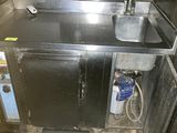 a kitchen with a sink and a refrigerator in it