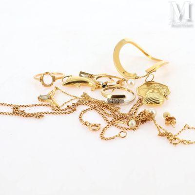 a pile of gold jewelry on a white surface