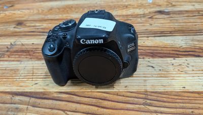 a canon camera sitting on a wooden table