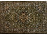 an antique persian rug with a medallion design on a green ground