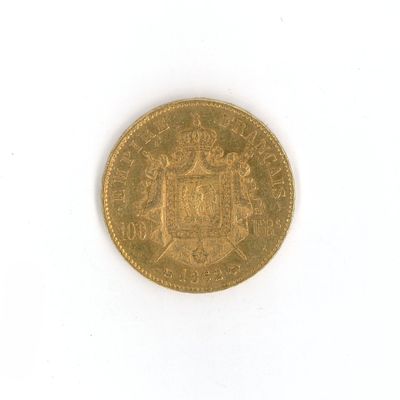 an old gold coin on a white surface with a white background