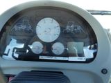 a close up of a car dashboard with a clock on it