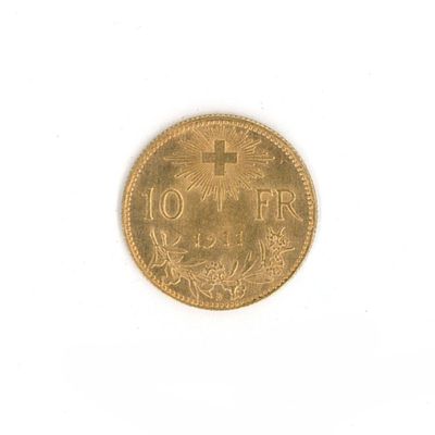 an old coin with a cross on it on a white surface
