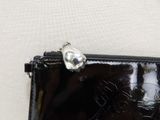 a small black purse with a skull on it