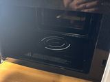 a microwave that is sitting on a table in a room