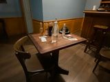 a wooden table with a glass of wine on top of it